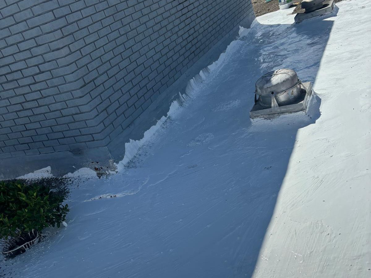 Low-slope roof section being inspected